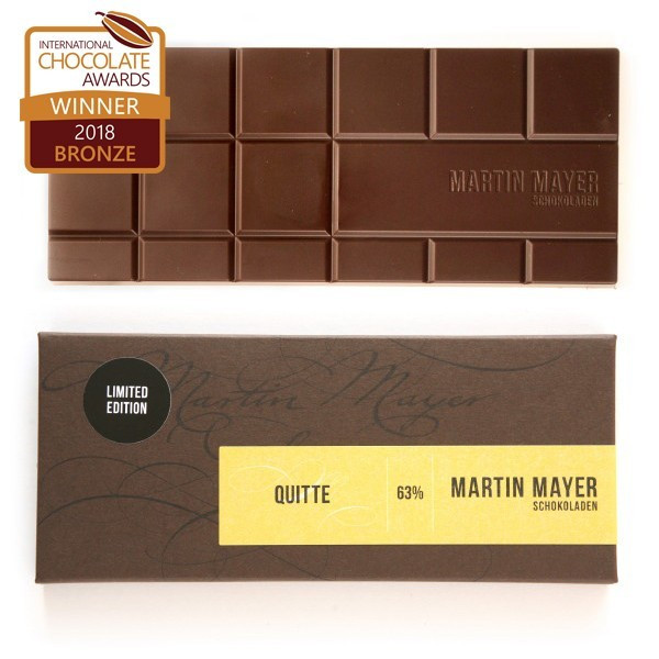 Martin Mayer gefüllte dunkle Schokolade mit Quitte - Verpackung aus dunkelbraunem Papier mit gelber Banderole.