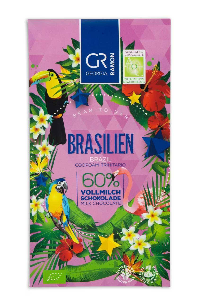 Verpackung der "Brasilien 60% Vollmilch" Schokolade von Georgia Ramon - rosa Hintergrund, darauf tropische Blatt- und Blumenelemente, im V ordergrund ein Tukan, ein Ara und ein Flamingo